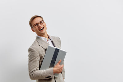 Portrait of businessman using digital tablet against white background
