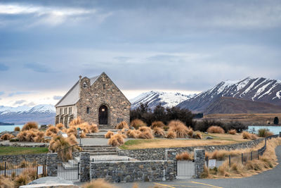 Sunrise view of the church of good shepherd with beautiful snow capped mountain range. 