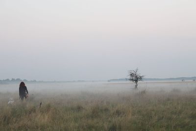 Scenic view of grassy field against sky