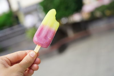 Close-up of hand holding ice cream cone