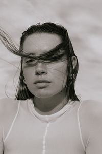 Portrait of young woman against sky