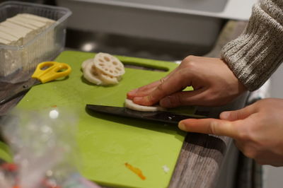 Midsection of man preparing food on cutting board