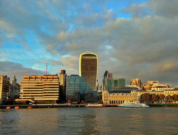 Cityscape against cloudy sky