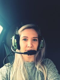 Portrait of woman wearing headphones in helicopter