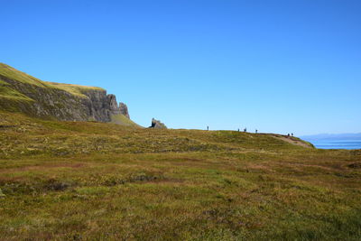 Scenic view of land against clear blue sky