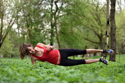 Portrait of mid adult woman exercising at public park