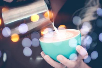 Close-up of hand holding candles