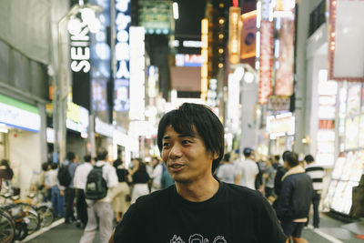 Portrait of smiling man standing on street in city