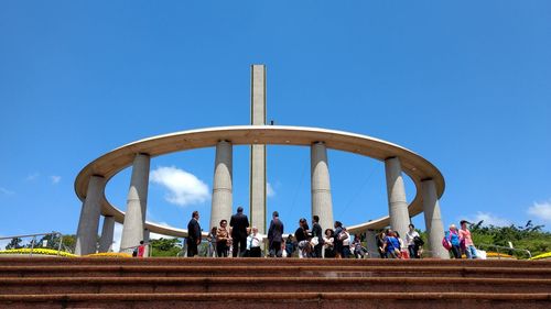 People against clear blue sky