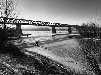 Man on bridge against sky