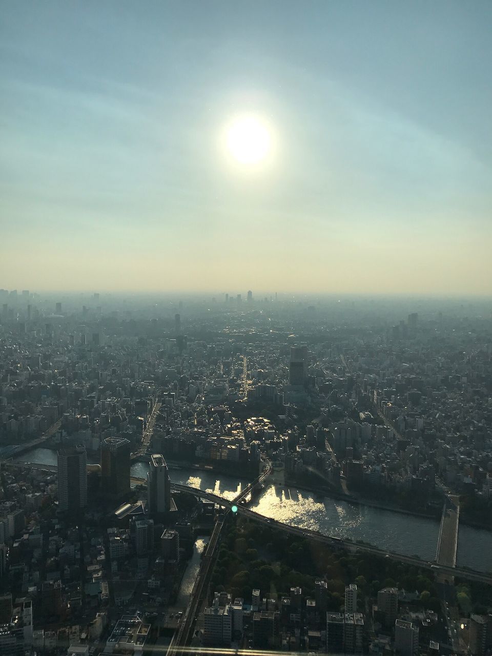 HIGH ANGLE VIEW OF CITY AGAINST SKY DURING SUNSET