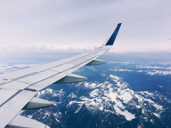 Aerial view of aircraft wing against sky