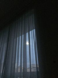 Low angle view of sky seen through home window