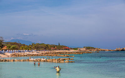 People on beach against sky