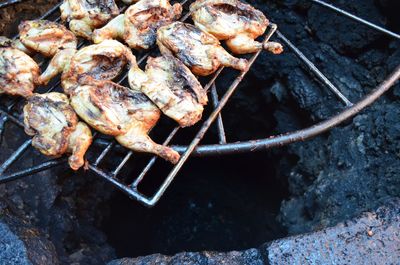High angle view of roasted chicken on barbecue
