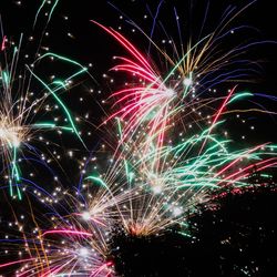 Low angle view of firework display at night