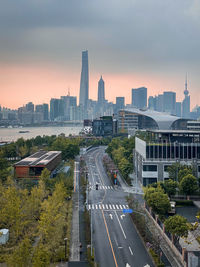 High angle view of city buildings against sky during sunset