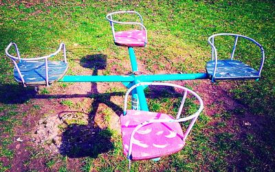 Empty bench in grassy field