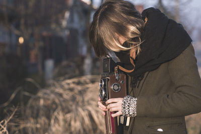 Young woman photographing through camera