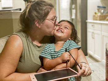 Mother and daughter while using mobile phone
