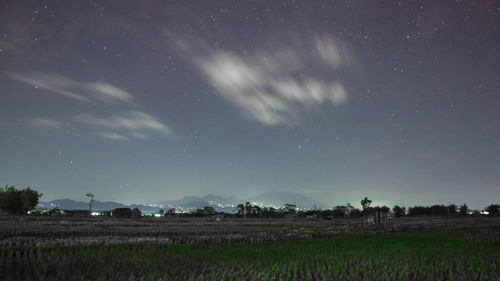 Scenic view of field against sky at night