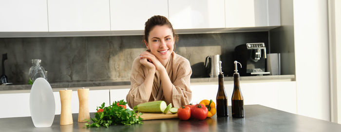 Portrait of young woman sitting at home