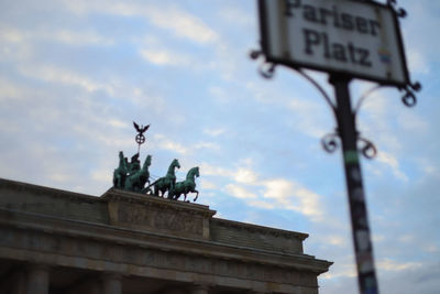 Low angle view of statue against cloudy sky