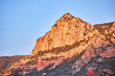 Low angle view of rock formations against clear sky