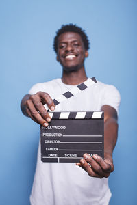 Portrait of young man using digital tablet against white background