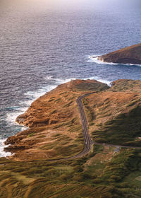 Scenic view of land by sea