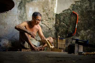 Portrait of shirtless man working