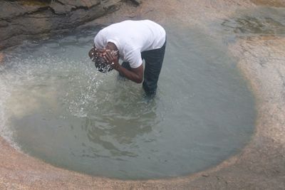 Rear view of man standing at beach