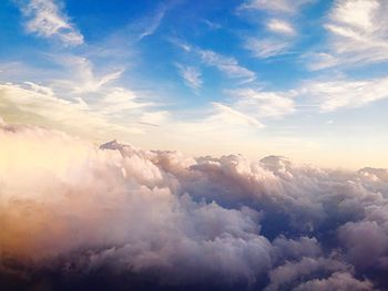 Aerial view of mountain range against cloudy sky