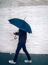 Man with umbrella standing on ground