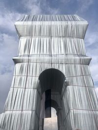 Low angle view of building against cloudy sky