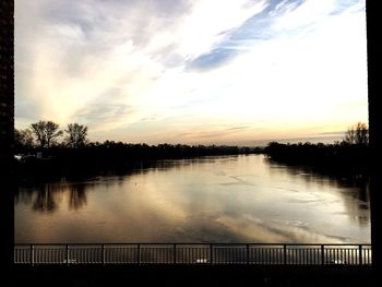 Scenic view of lake against sky during sunset