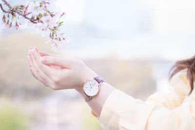 Close-up of hand holding pink flower