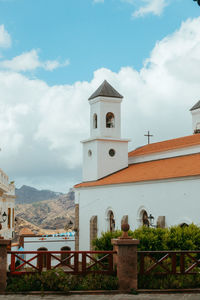 Low angle view of building and mountains against sky