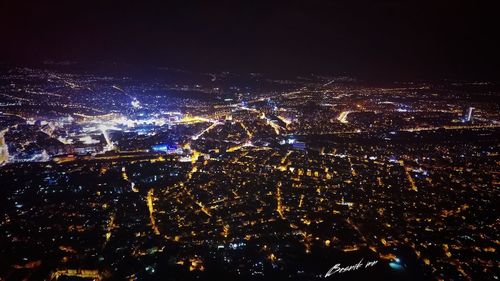 Aerial view of illuminated city at night