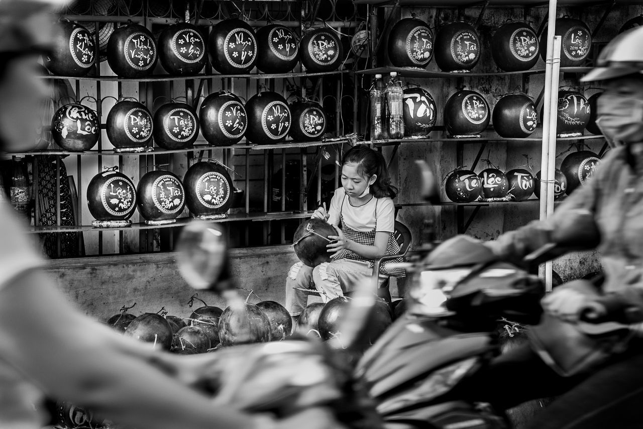 real people, focus on background, indoors, lifestyles, selective focus, casual clothing, people, men, child, adult, women, sitting, leisure activity, two people, childhood, architecture, females, boys, togetherness