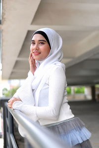 Portrait of a smiling young woman sitting on seat