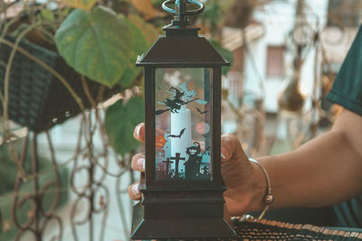 Close-up of hand holding lantern