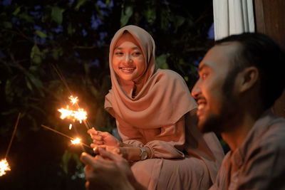 Happy couple holding sparklers