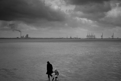 Silhouette of dog against sea