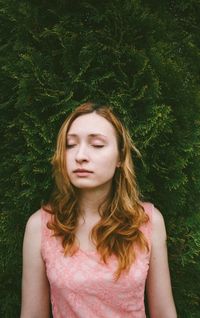 Portrait of young woman in grass