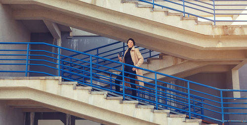 Low angle view of woman standing on staircase