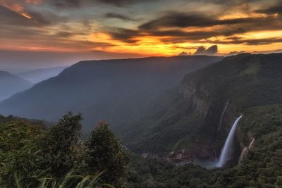 Scenic view of mountains against sky at sunset