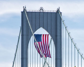 Low angle view of flag against cloudy sky