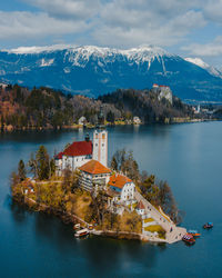 Scenic view of lake and buildings against sky