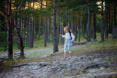 Portrait of girl walking in forest